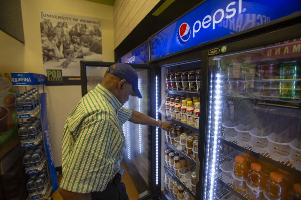 <p class="p1"><span class="s1"><strong>Howard Covington, a University of Memphis dining services employee, stocks drinks in the University Center. Covington has worked for the University for 37 years.</strong></span></p>