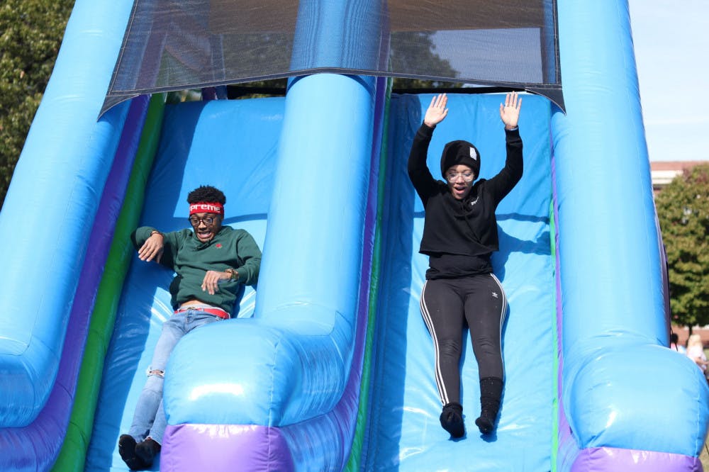 <p>Two University of Memphis students slide down the end of the obstacle course at the LGBTQ+ kickoff field day. Stonewall Tigers, organizers of the week's events, aim to show students sexuality does not make someone different from any other person.</p>