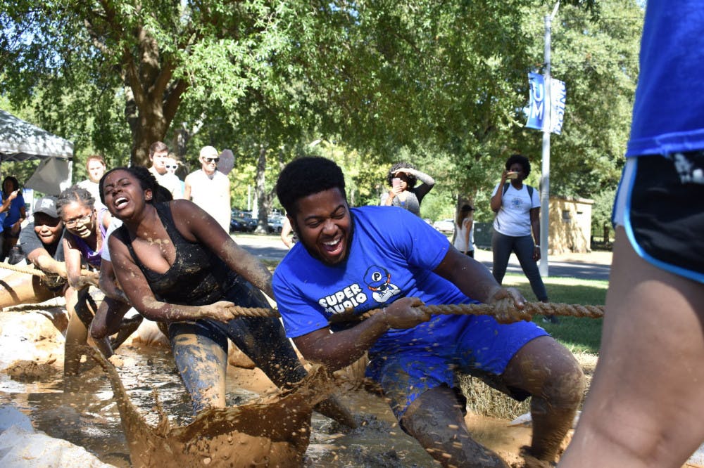 <p>Student Ambassador Board (SAB) member Jeffrey Houston and his team compete during muddy tug-of-war. SAB’s ‘Mudball Tournament’ was held on Browning Hall Lawn.</p>