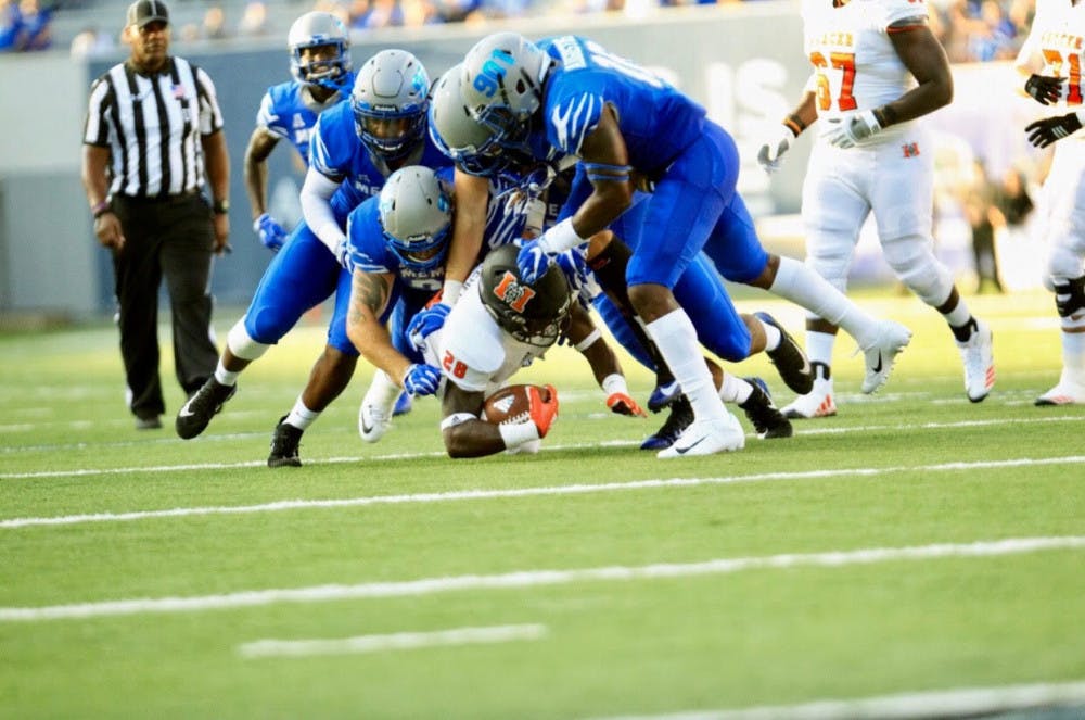 <p>Tee Mitchell (28) falls to the ground as he is getting tackled by the Memphis defense. Despite the powerful defense by Memphis, Mercer scored 14 points.</p>