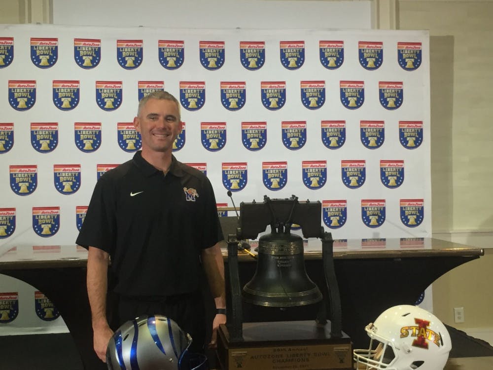 <p>Memphis head coach, Mike Norvell stands with the AutoZone Liberty Bowl trophy. This is the first time in program history the Tigers received a bid to the bowl.</p>