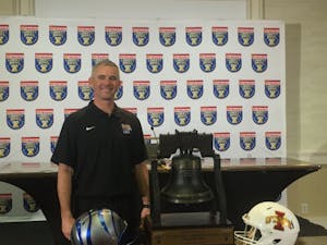 Norvell with Liberty Bowl trophy