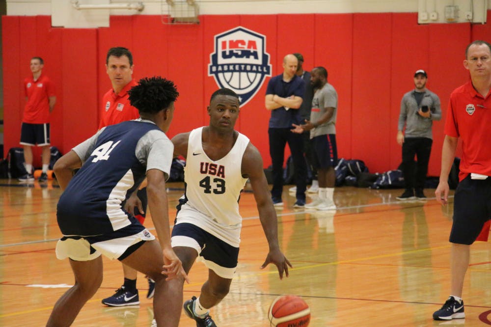 <p>Memphis signee Alex Lomax drives past a defender at USA Basketball camp. Lomax called out plays and ran the offense as a floor general.</p>
