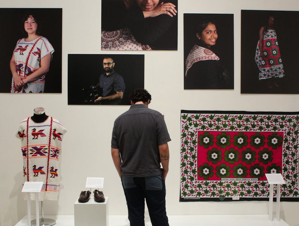 A visitor admires the works of students at the Snailhouse exhibit opening on Saturday.