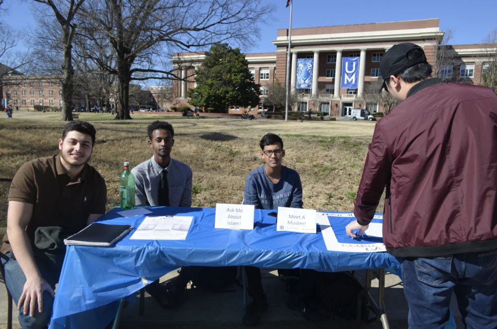 <p>Members of the Muslim Student Association, 19-year-old political science major Ata Amro, 21-year-old biology major Adio Abdurahaman, 18-year-old law student Muhammad Quadir and 20-year-old business major Zhuo Xue host a tabling event where they answer questions other students might have about the Muslim faith. They were giving out information about nearby mosques, so students could visit if they have any additional questions.&nbsp;</p>