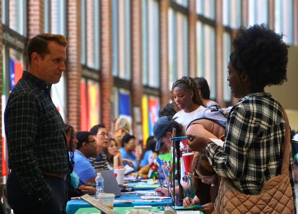 <p>Students speak with representatives at the University of Memphis study abroad fair Sept. 11 in the Rose Theater lobby.</p>