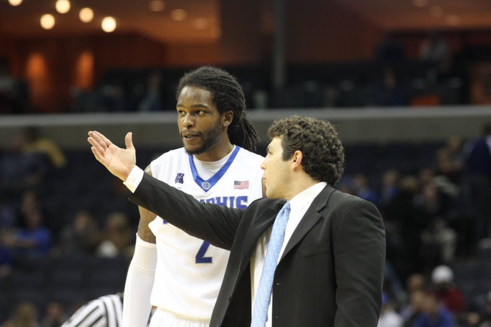 <p>Former University of Memphis men’s basketball coach Josh Pastner and former forward Shaq Goodwin talking during a game. Goodwin was one of four players to play four seasons under Pastner.&nbsp;</p>