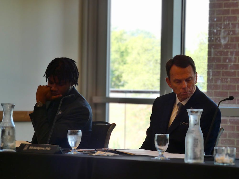 <p>University of Memphis SGA President Chris Bailey (left) and UofM President Bill Hardgrave listen during the Board of Trustees’ first meeting of the 2025-26 academic year at the Maxine A. Smith University Center on Tuesday.</p>
