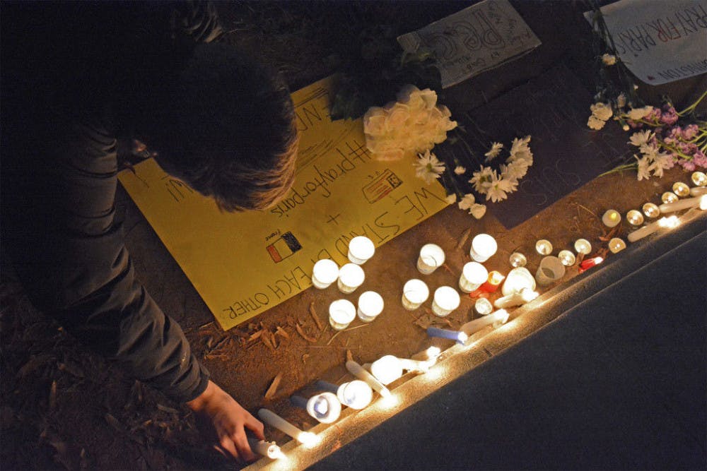 <p>Days after the Paris attacks, people in Washington D.C. held a candle light vigil for those who died. Many placed candles next to flowers and a sign that reads "We stand with each other" and "Je Suis Paris #PrayforHumanity"&nbsp;</p>