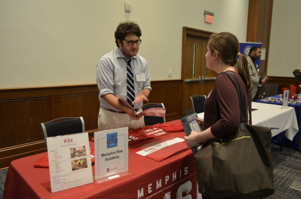 <p><strong>Jack Vuylesteke talks to Elizabeth Brame (26, counseling graduate student) about the Memphis Rise Academy at the “Education Fair” Nov. 7.&nbsp;</strong></p>