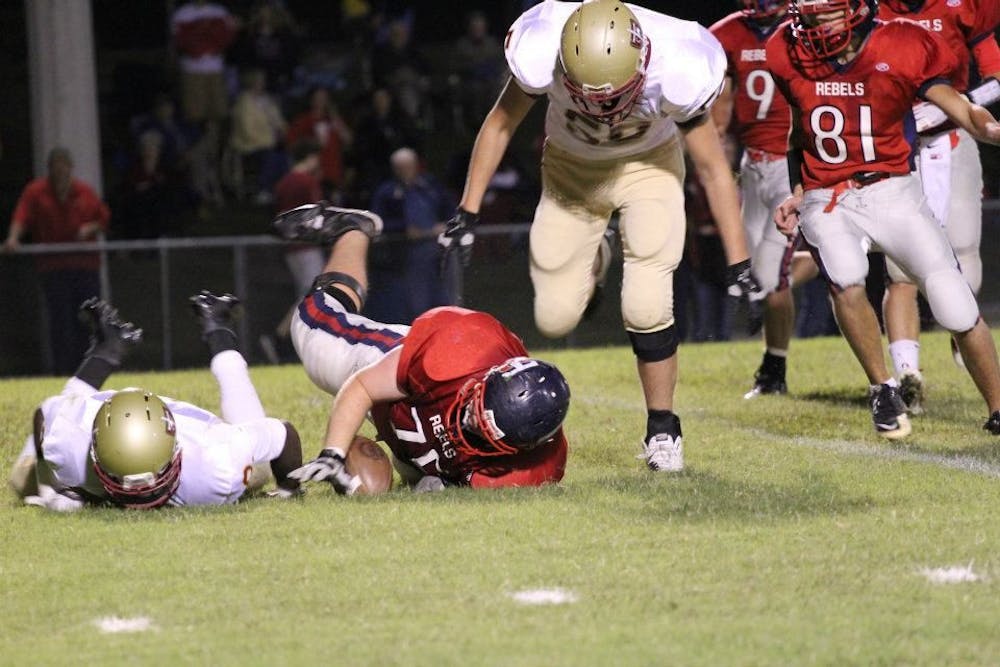 <p>Sam Watson, pictured in the middle holding onto the ball, starred at Tipton-Rosemark Academy in Millington. He was named the team’s MVP in his senior season and played three different positions: center, offensive tackle and defensive tackle. Photo by Leighann Wilson</p>