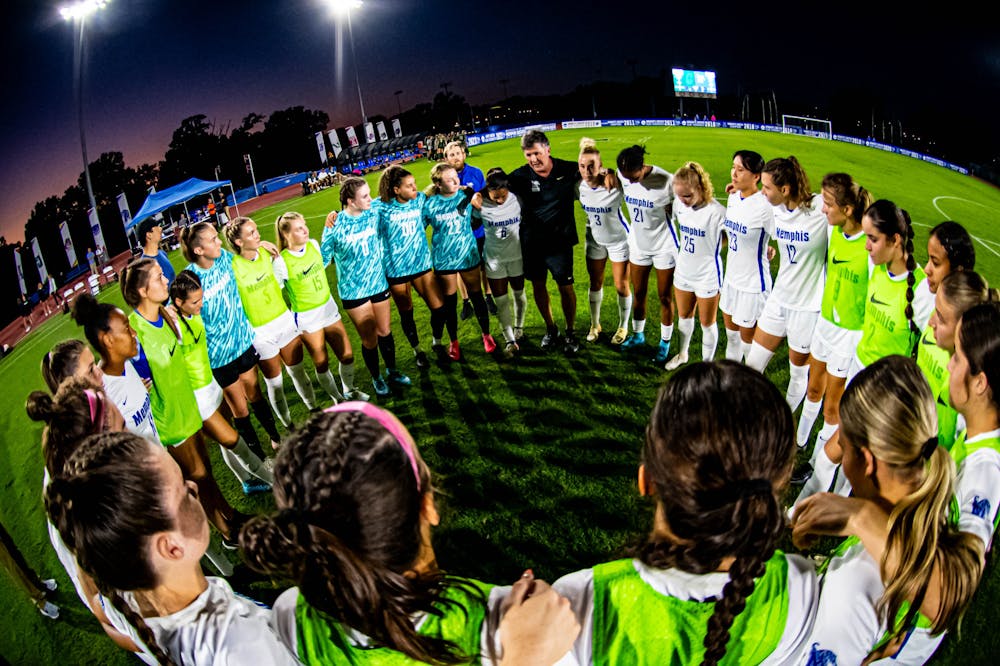 Memphis women's soccer huddles before a home match.