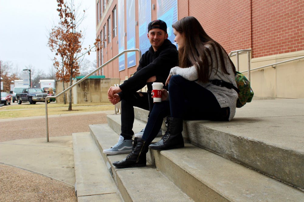 <p>Students Chase Sutton and Anelises Kilpatrick sit on the steps of the University Center using Starbucks coffee to warm up. Drinking a hot drink like coffee or hot tea can be one of the most simple but most effective ways to stay warm during the winter months.&nbsp;</p>