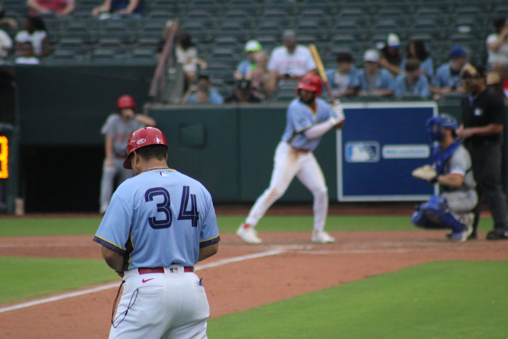 Manager Ben Johnson looks on as Victor Scott II bats in the Redbirds' 8-0 win against Durham on Grizzlies night.