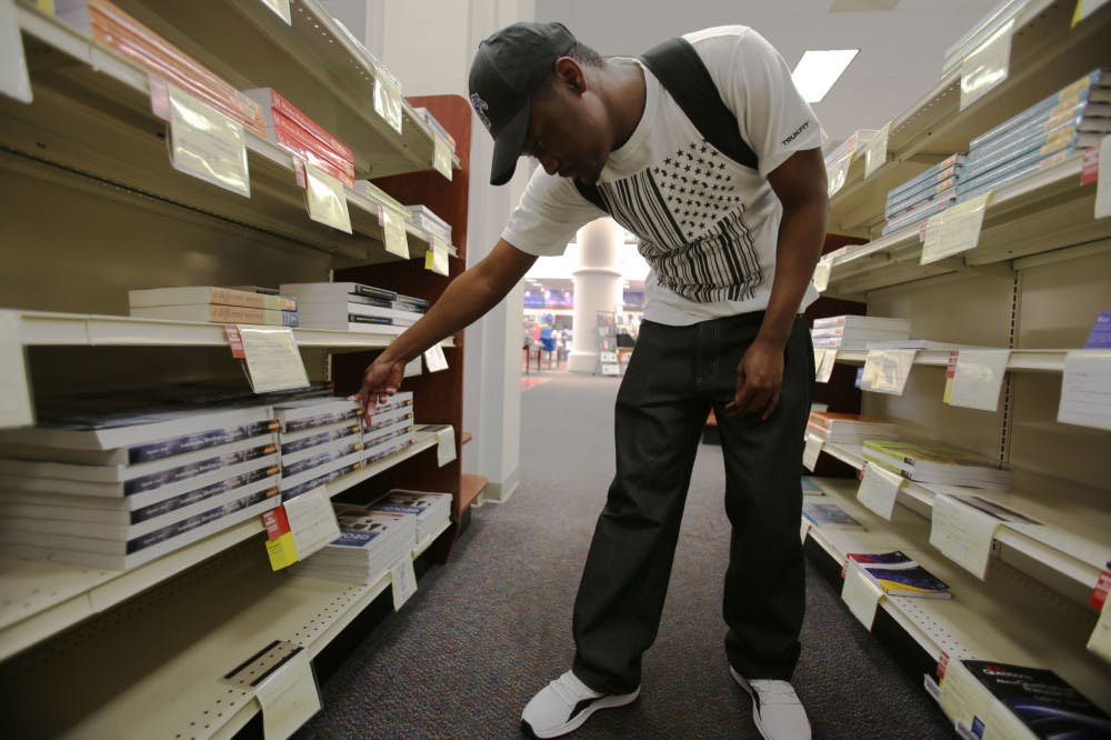 <p>Malik Shelluy, a junior accounting major, looks at books in the University bookstore.</p>