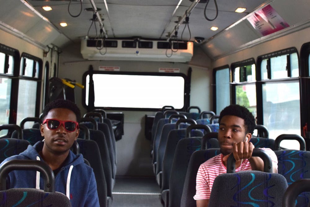 <p>Sophomores Patrick Cephus (left) and Clentis Jennings (right) were two of three passengers on the Blue Line Tuesday afternoon. Cephus, a political science student, said that he does not use the bus line that often.&nbsp;</p>