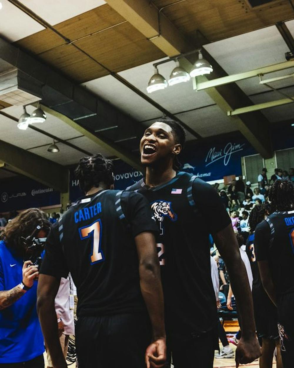 Dain Dainja and PJ Carter celebrate the Tigers' win over UConn.