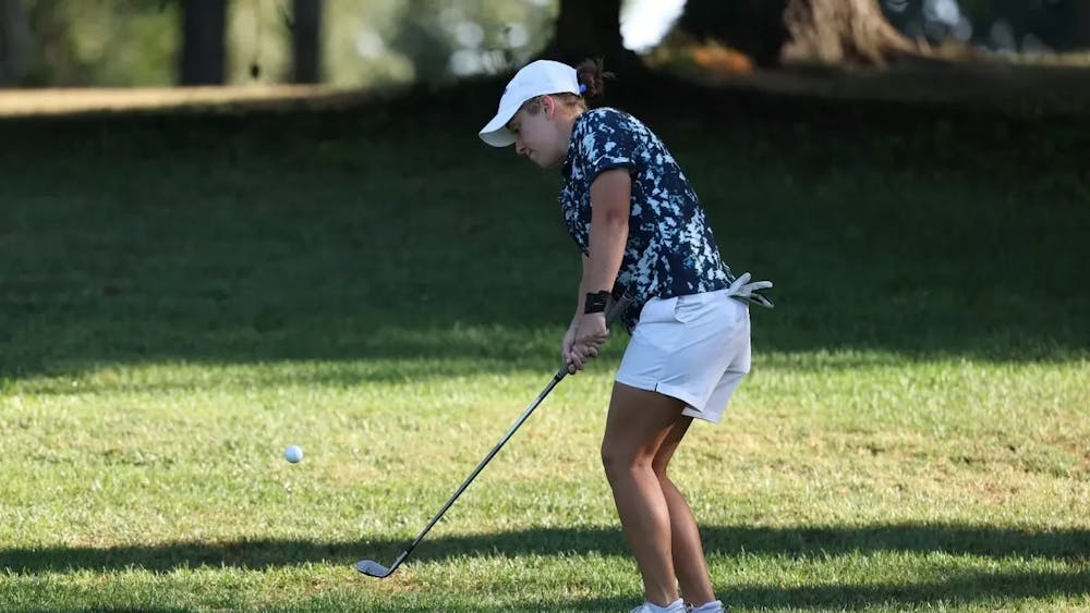 Sophomore Claire Swathwood chips a ball towards the green in the Lady Red Wolves Classic Tuesday.