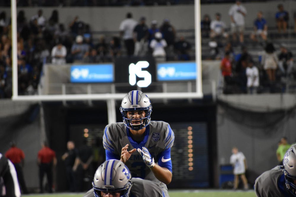 <p>Brady White stands behind the line of scrimmage calling his offense. White finished the night completing 19 of his 26 pass attempts for 269 yards and five touchdowns.</p>