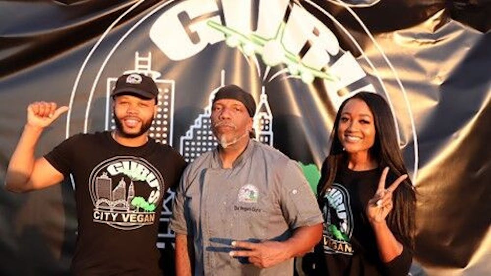 <p>Co-founders Vince “City” McMillan, Daudi “Da Vegan Guru” McLean and director of operations De’Ja Monae pictured at their pop-up event at Grind City Brewery Oct. 23. The pop-up featured vegan soul food like fried chicken and seafood plates.</p>