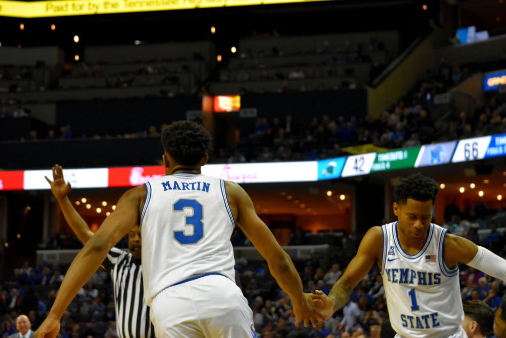 <p class="p1"><span class="s1"><strong>Jeremiah Martin and Tyler Harris celebrate after Martin hit a three pointer in front of the Memphis bench. Martin scored a career-high 43 points, eight assists and seven rebounds.</strong></span></p>