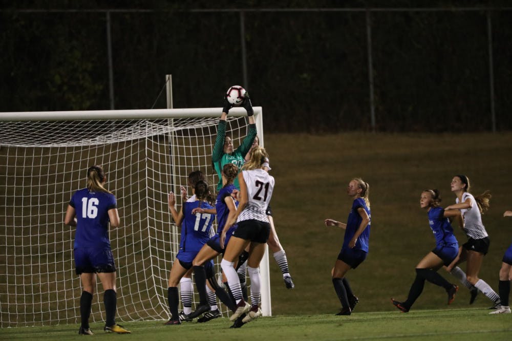 <p>Elizabeth Moberg does her best vertical jump to secure the ball in the air. Moberg leads the nation in shutouts with 10.&nbsp;</p>