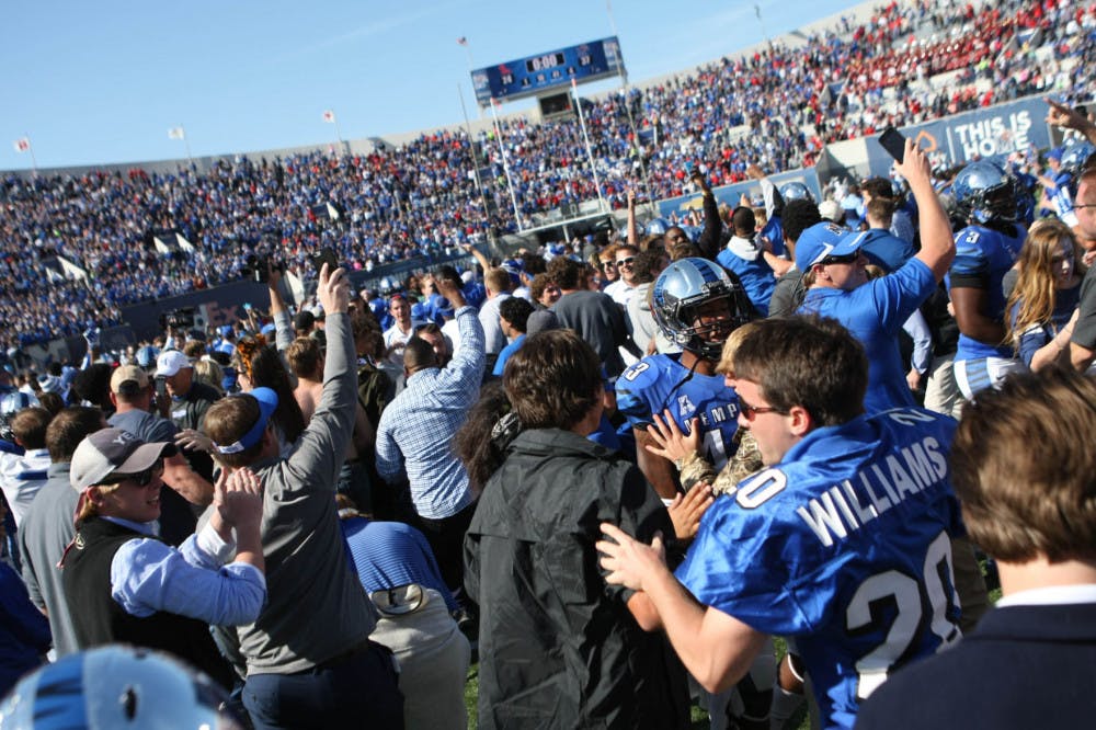 <p>Memphis fans storm the field after their upset victory over No. 13 Ole Miss last season. Despite being underdogs again this season, Memphis fans are optimistic about their chances.</p>