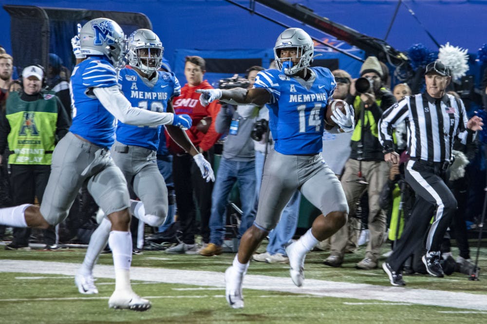 <p>Antonio Gibson celebrating a touchdown run by pointing at his teammate.&nbsp;Gibson ended with 386 all-purpose yards which set a school record. (Frank Ramirez/Daily Helmsman)</p>
