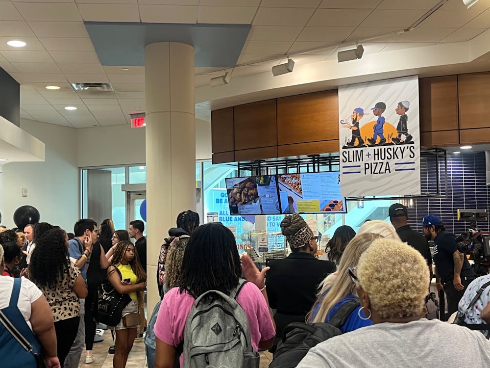 <p>Students crowd the University Center food court during the grand opening of Slim &amp; Husky&#x27;s Pizza.﻿</p>