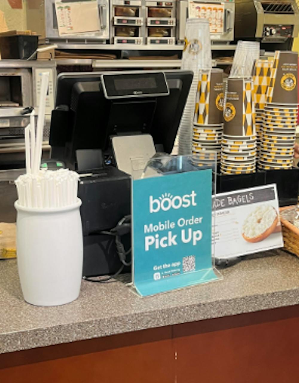 <p>A sign showing where to pick up a Boost order at Einstein&#x27;s Bagels.</p>