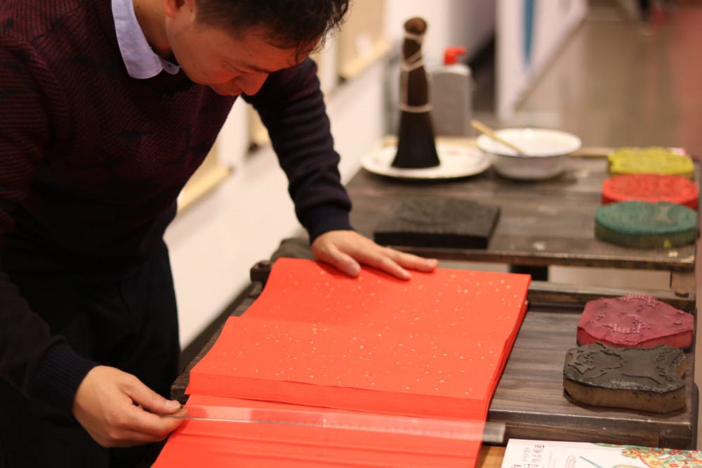 <p>A student from China begins making a print in the traditional woodblock style typically used in ancient Lunar New Year celebrations. Students will be able to make their own art print during the workshop from 11:30 a.m. - 2:20 p.m. at room 312 in the arts and communication building.</p>