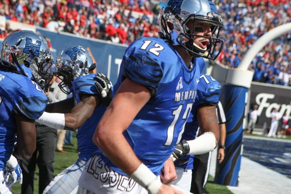 <p>Former University of Memphis quarterback Paxton Lynch celebrates a touchdown against Ole Miss last season. Lynch is projected to be selected in the first round of the 2016 NFL Draft, which begins Thursday.&nbsp;</p>
