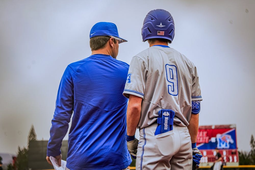 Memphis infielder Alex Fernandes talks to his hitting coach, as the Tigers fall in extra innings to Jacksonville State 6-5.