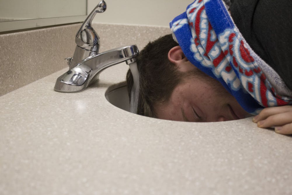 <p class="p1"><strong>Freshman LLC resident, Rylie Gordon, is forced to wash his hair in the sink before class because it is the only source of warm water in his hall.&nbsp;</strong></p>