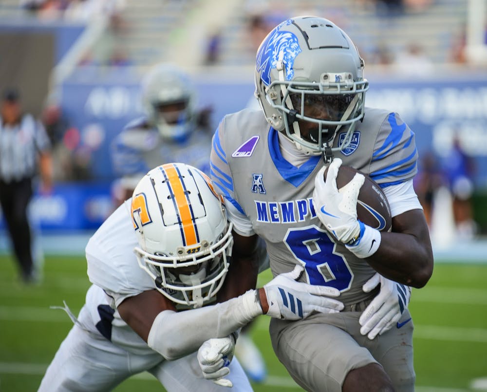 <p>Memphis receiver Bryce Dorsey evades a tackle in the Tigers&#x27; 45-10 victory over Chattanooga Saturday afternoon at Simmons Bank Liberty Stadium.﻿</p>