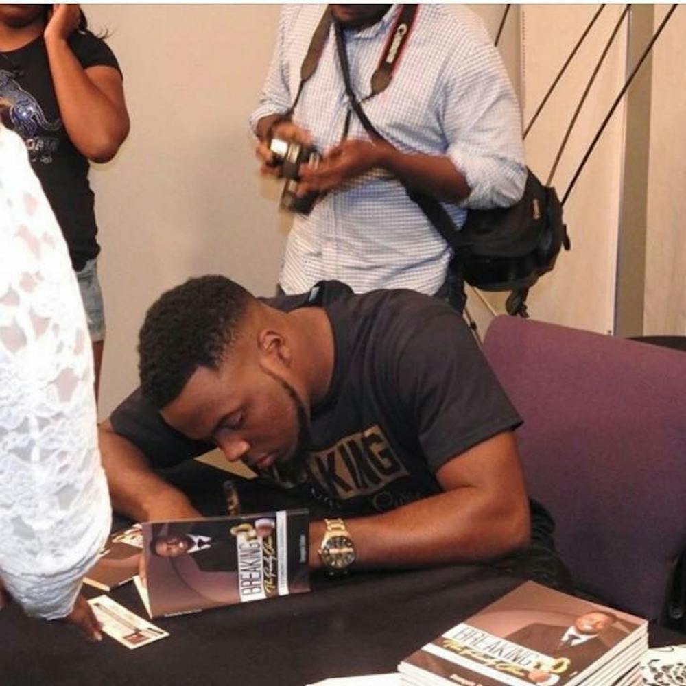 <p>Collier greets readers and signs their books at a book signing in June 2016. He published <em>Breaking the Family Curse: Testimony Still Loading...&nbsp;</em>and plans to write more books in the future.</p>