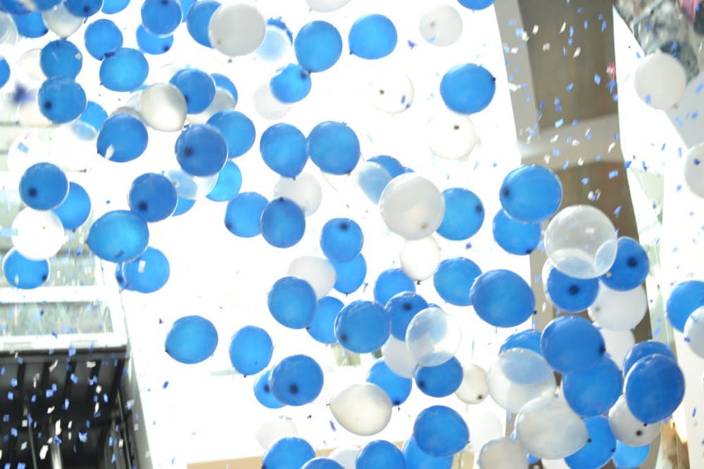 <p>The University of Memphis celebrated the hours its students put into serving the community Thursday at the University Center Atrium. David Rudd, U of M president, and wife Loretta Rudd, a clinical associate professor in child development, stand with students Melissa Byrd and Jared Moses as confetti and balloons fall from the sky light. Students did more than 600,000 hours of community service.</p>
<p>PHOTO BY Jonathan Capriel</p>