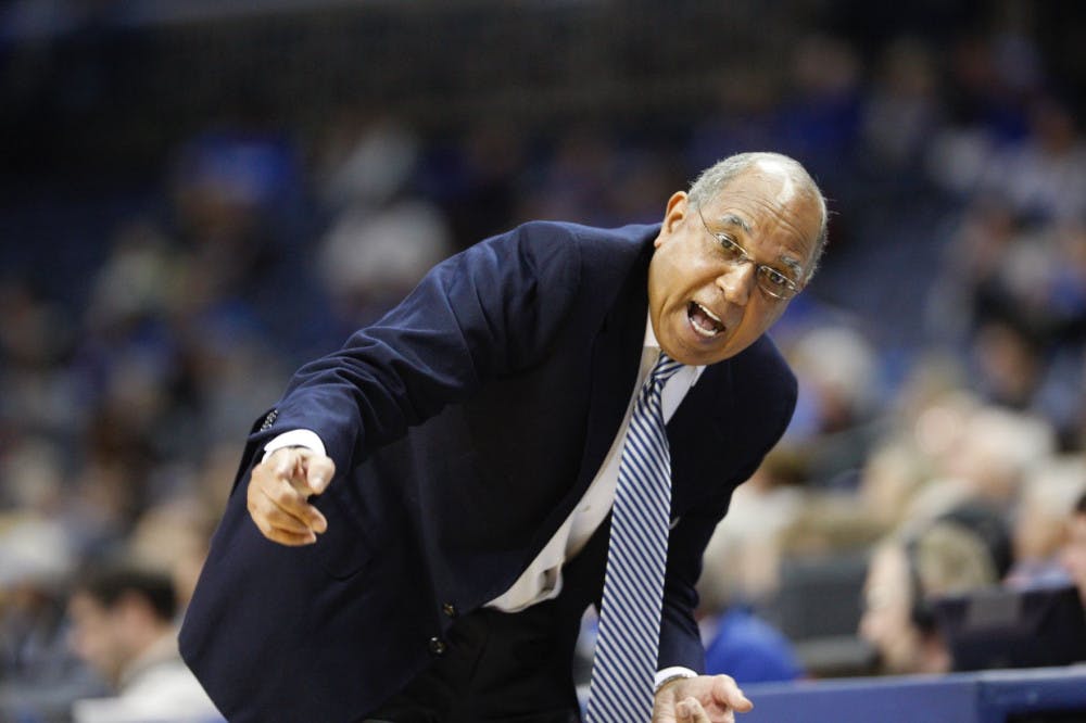 <p>Tubby Smith talks to his players on the bench during a game. Smith won 19 games during his first year with the Tigers.</p>