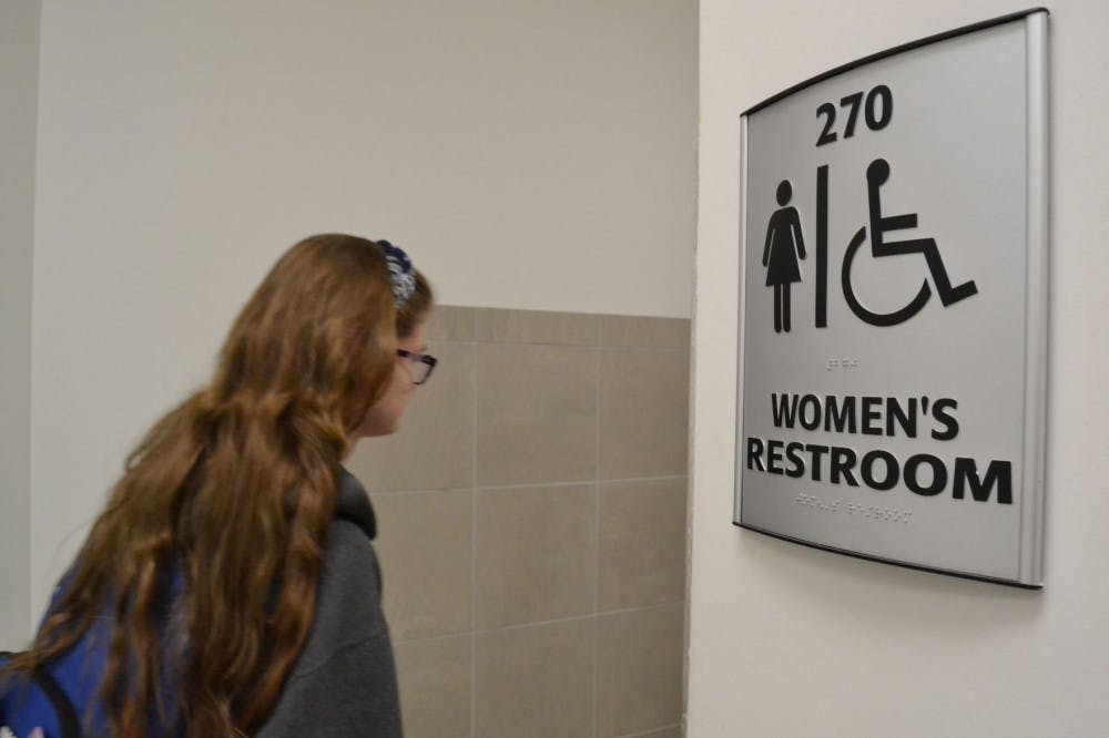<p>A student goes into the women's restroom on the second floor of the University Center.&nbsp;</p>
