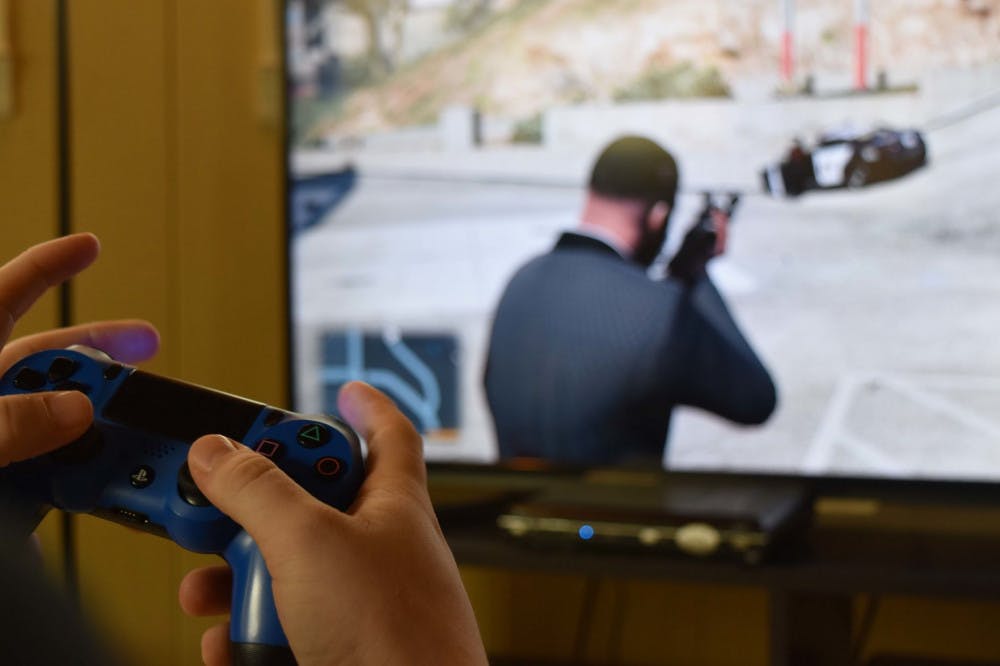 <p>A student plays first-person shooter video game Grand Theft Auto 5 at his home near campus. President Donald Trump said last week that violent video games and movies contribute to real-life violence like school shootings.</p>