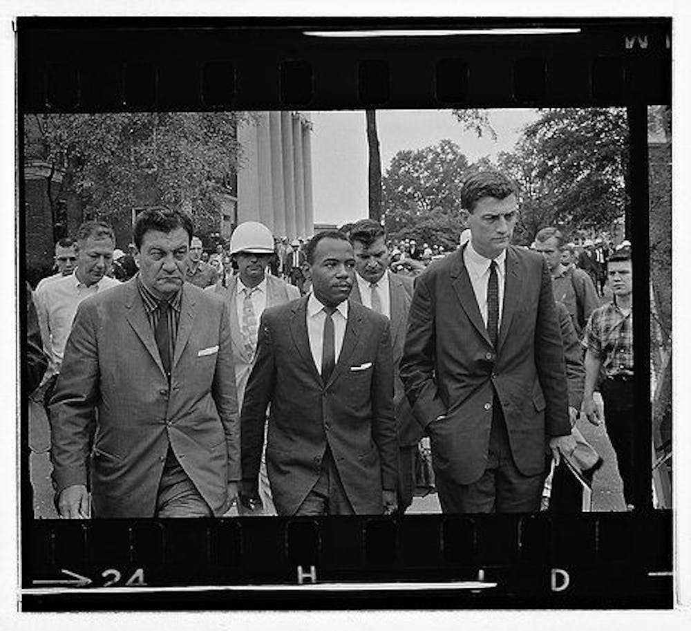 <p class="p1"><span class="s1"><strong>James Meredith walking to class accompanied by United States marshals on his first day at the University of Mississippi on Oct. 1, 1962.</strong></span></p>