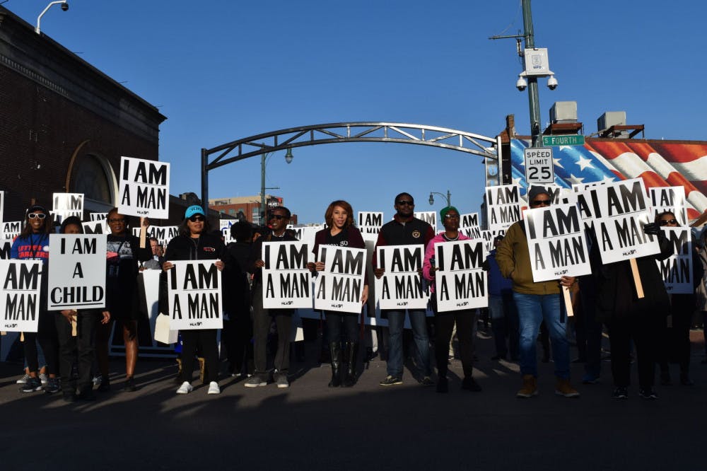 <p>Participants line up to take a re-enactment photo of the famed 1968 Sanitation Strikers. The photo was taken from a drone April 4.</p>