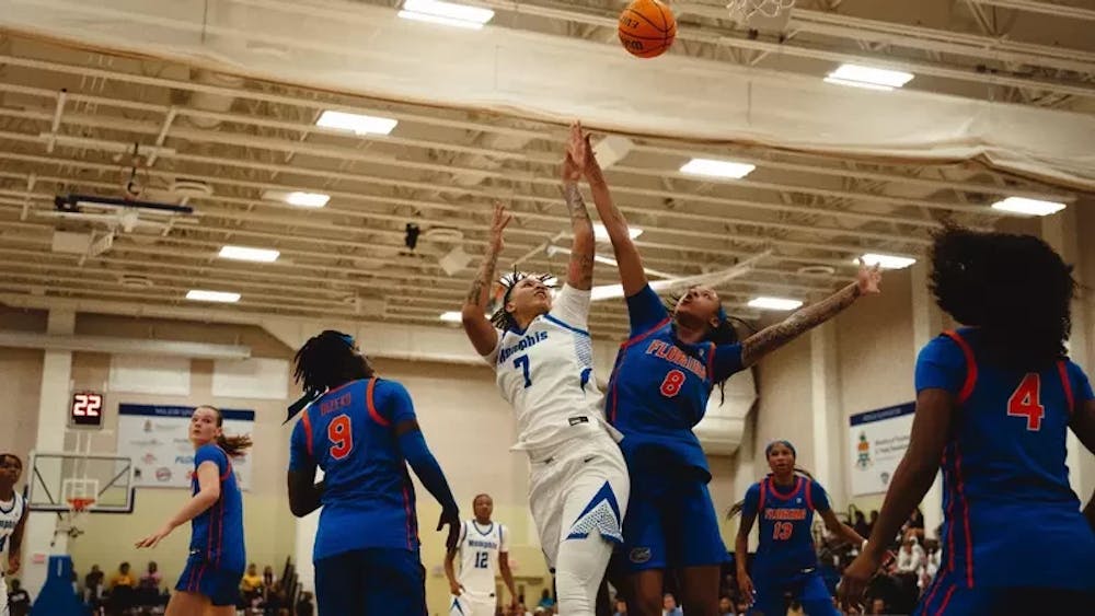 <p>Memphis forward Paris Gaines battles for a rebound in the Tigers&#x27; game against Florida in the Cayman Islands Classic. She finished with three points after six minutes of play.</p>