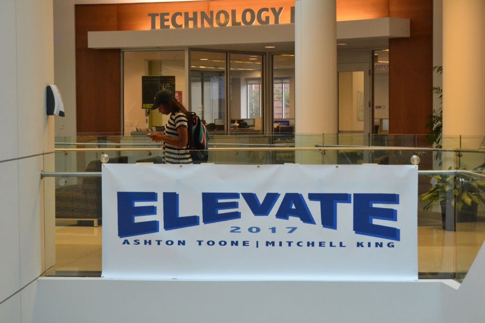 <p>A sign for the Elevate party hangs in the University Center. About 15 signs similar to this banner were stolen from areas across campus last week.&nbsp;</p>