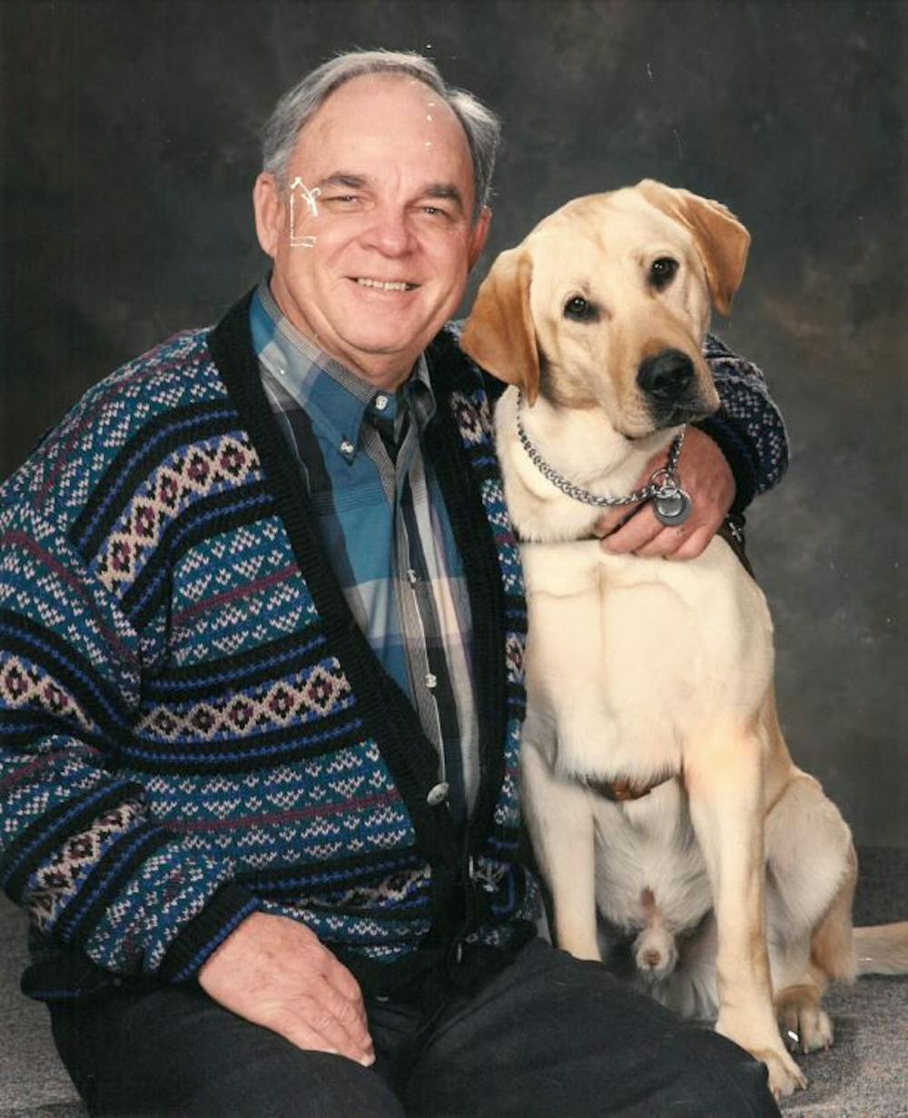 <p class="p1"><strong><span class="s1">Dallas Foscue, whose vision faded in 1991, holds his seeing-eye dog named Niblett.</span></strong></p>