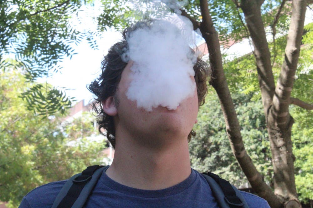<p class="p1"><span class="s1">A student takes a break from classes by smoking an e-cigarette. The FDA recently launched an ad campaign to attempt to decrease teen e-cigarette use.</span></p>