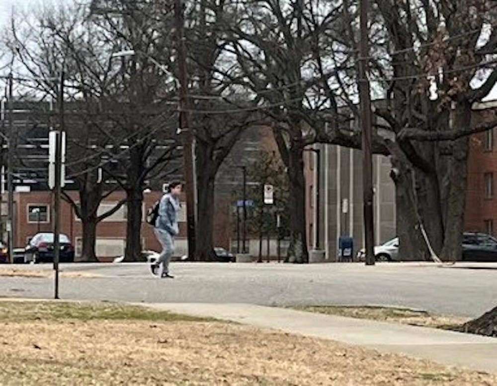 A student walks across the street at Patterson and Midland Ave. intersection 