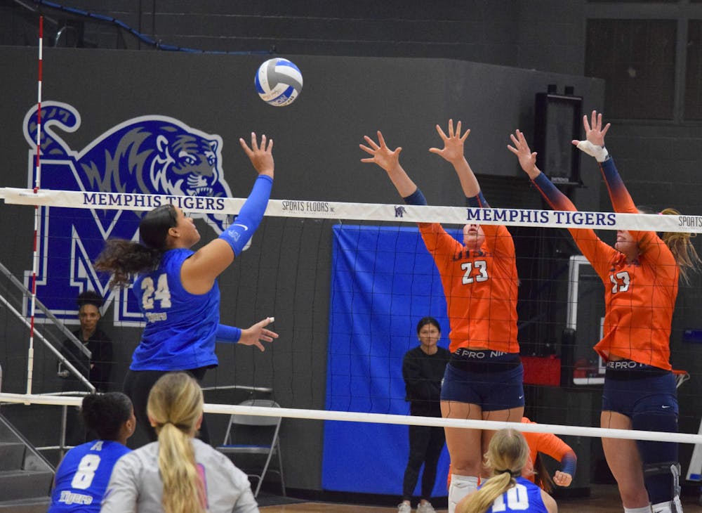<p>Memphis&#x27; Jasmyn Tate spikes a ball over the net towards two UTSA defenders in the Tigers&#x27; 3-0 loss to the Roadrunners Friday night at Elma Roane Fieldhouse.﻿</p>