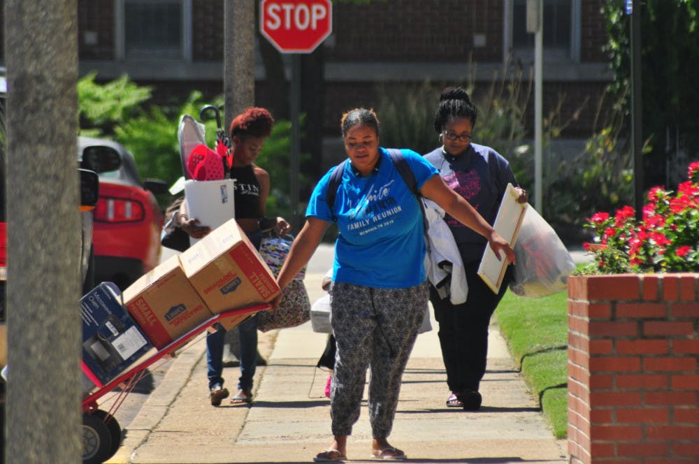 <p>Briuna White (left) moves into Rawls Hall with help from her family. Only about 14 percent of U of M students live in on-campus housing, as the university is primarily a commuter school.</p>