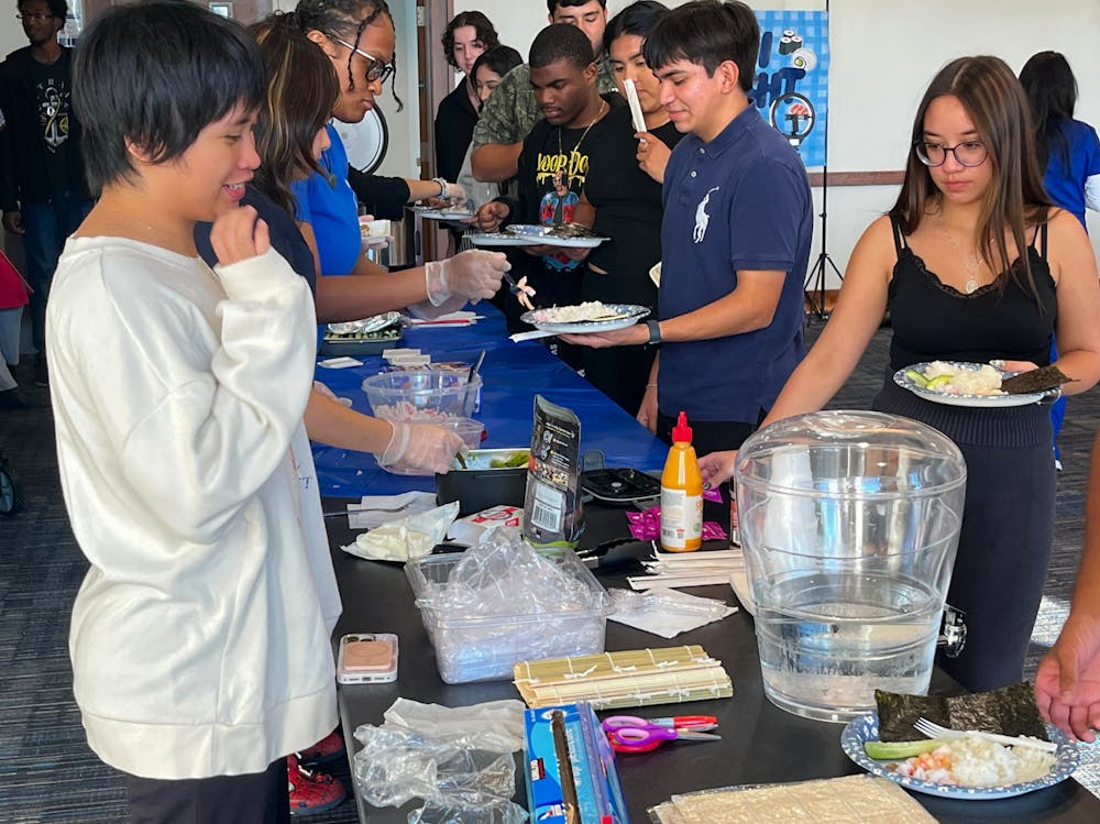 <p>Students line up to make their own sushi during the Asian American Association’s Sushi Night on Oct. 16 in the University Center.</p>